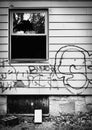 Abandoned house with broken window and graffiti. Royalty Free Stock Photo