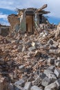 An abandoned house collapses. The house is destroyed. Cracks in wall of house. Destruction of old houses, earthquakes