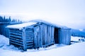 Abandoned house covered with frost over winter forest and snow Royalty Free Stock Photo