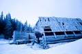 Abandoned house covered with frost over winter forest and snow Royalty Free Stock Photo