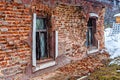 An abandoned house, with crumbling brick walls and barred windows Royalty Free Stock Photo