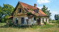 Abandoned house with damaged roof and overgrown vegetation