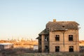 Abandoned house facing old factories and warehouses with their distinctive chimneys in Eastern Europe, in Pancevo, Serbia