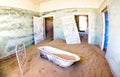 Abandoned house full of sand from the desert in the forsaken ghost town of Kolmanskop near Luderitz in Namibia Royalty Free Stock Photo