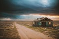 Abandoned house next to a dirt rural road with scattered debris after a hurricane. Consequences of natural disaster Royalty Free Stock Photo