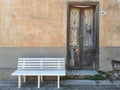 Abandoned house with pristine white bench