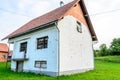 Abandoned House Remained Damaged after the Civil War in Croatia. Walls are full of Bullet Holes and Windows are Blocked with Board