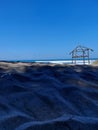 ABANDONED HUTS ON THE SAND BY THE SEA ADD TO THE NATURAL AESTETIC