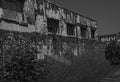 Abandoned Industrial Building and Barbed Wire Coils Black and White