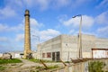 Abandoned industrial building with a high brick chimney Royalty Free Stock Photo