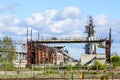 Abandoned industrial building with rusty bridge crane at scrap metal recycling metallurgical plant Royalty Free Stock Photo