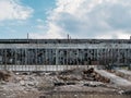 Abandoned industrial creepy warehouse exterior or facade, old dark grunge factory building with broken windows