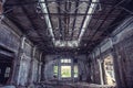 Abandoned industrial creepy warehouse inside with big broken window, old dark grunge factory building Royalty Free Stock Photo
