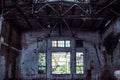 Abandoned industrial creepy warehouse inside with big broken window, old dark grunge factory building Royalty Free Stock Photo