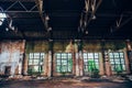 Abandoned industrial creepy warehouse inside with big windows, old dark grunge factory building Royalty Free Stock Photo