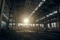 Abandoned industrial creepy warehouse inside old dark grunge factory building in sunlight Royalty Free Stock Photo