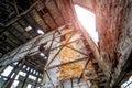 Abandoned industrial interior of the factory without windows and many holes on the background of the ceiling Royalty Free Stock Photo