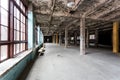 Abandoned industrial interior with hall and big windows Royalty Free Stock Photo