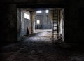 Abandoned industrial interior with rubble on floor, broken glass and wooden stairs Royalty Free Stock Photo