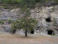 Abandoned industrial mines entrance, dark spooky asbestos shaft in rock, dangerous urban exploration, asbestos cancers