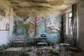 abandoned kindergarten with ruined desks and chairs overgrown urbex