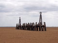 Abandoned landing stage at saint annes pier in the ribble estuary lancashire at low tide with grey clouds Royalty Free Stock Photo