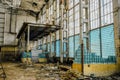 Abandoned large industrial hall. Broken wall from glass blocks Royalty Free Stock Photo