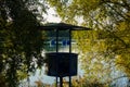 Abandoned life guard tower surrounded by autumnal colourful trees