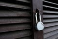 Abandoned locked door of a garage, shed or warehouse. Old and forgotten metal aged padlock on a closed secure facility. Spider web Royalty Free Stock Photo