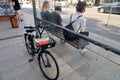 Abandoned locked rental bike at the back of glass bus stop