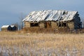 Abandoned Log Cabin And Granaries In Winter