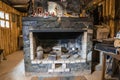 Stone brick wall fireplace with antique tools in abandoned room Royalty Free Stock Photo