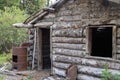 Abandoned log cabin with rusty barrel in Silver City ghost town, Yukon Territory, Canada Royalty Free Stock Photo