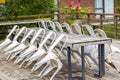 Abandoned long conference table and stools outdoors