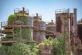 Abandoned machines and storage units in a gas industry at gas works park Seattle showing vine growth Royalty Free Stock Photo