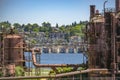 Abandoned machines and storage units in a gas industry at gas works park Seattle with water and homes Royalty Free Stock Photo