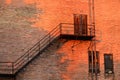 Abandoned Outdoor Rusted Staircase With Orange Sun Glow On Ruined Building Royalty Free Stock Photo