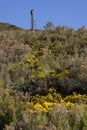 Abandoned metal tower structure in mountain landscape of Asturias Spain on a bright day