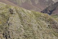 Abandoned metal tower structure in mountain landscape of Asturias Spain on a bright day