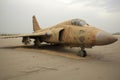 abandoned military fighter jet covered in sand