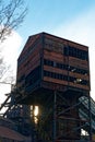 Abandoned Mining Tower At Sunset. Neglected Industrial Monument With Peeling Paint And Broken Windows Royalty Free Stock Photo
