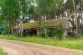 Abandoned narrow gauge railway, village and abandoned buildings, forest and lonely road in the middle