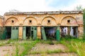 Abandoned narrow gauge railway, village and abandoned infrastructure buildings, forest and lonely road in the middle