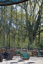 Abandoned nostalgic vintage whirligig in an amusement park with trees in the background