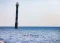 Abandoned oblique tilt lighthouse on the Baltic Sea. Some marine sandpiper birds and sea water on foreground Royalty Free Stock Photo