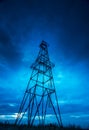 Abandoned oil rig, dramatic clouds and evening sky Royalty Free Stock Photo