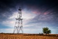 Abandoned oil rig, dramatic clouds and evening sky Royalty Free Stock Photo