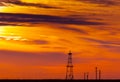 Abandoned oil rig, power lines and sunset Royalty Free Stock Photo
