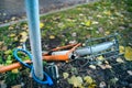 Abandoned old bicycle without wheels, chained to metal pole with blue locker. Royalty Free Stock Photo