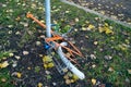 Abandoned old bicycle without wheels, chained to metal pole with blue locker. Royalty Free Stock Photo